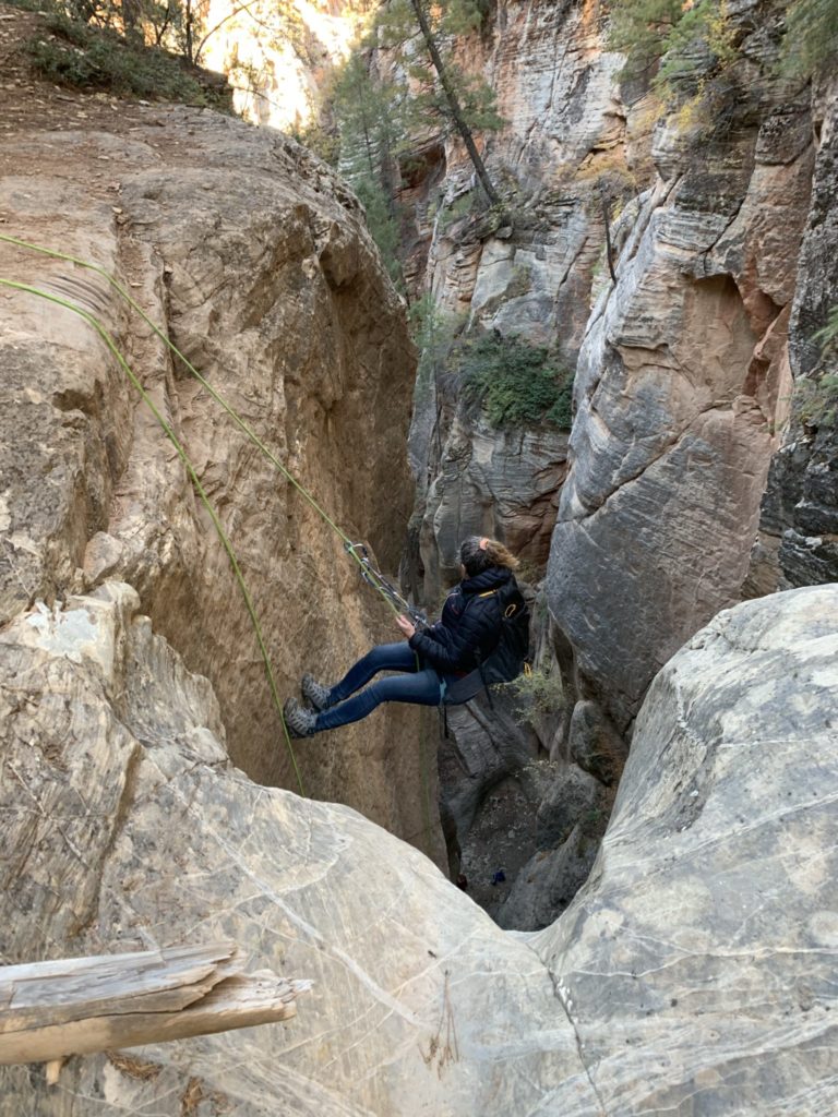 Woman at the top of a slot canyon rappell